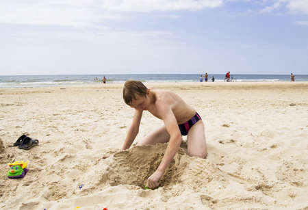 Young teenager playing on the beachの写真素材