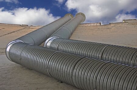 Ventilating pipes against the cloudy sky.の写真素材