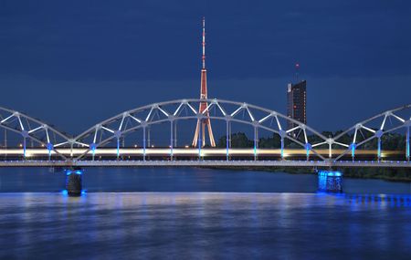 The night express train on the bridge across Daugava river.の写真素材