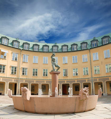 The circular building and fountain with statue in Stockholm, Sweden.の写真素材
