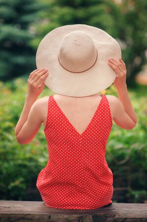 Portrait of beautiful against background of summer green parkの写真素材
