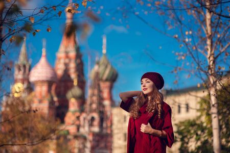 Portrait of a young beautiful blonde in a hat on a background of the city of Moscowの写真素材