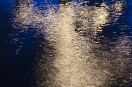 reflection of lights on the water creates an abstract patternの写真素材