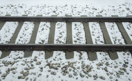 train tracks buried in snowの写真素材