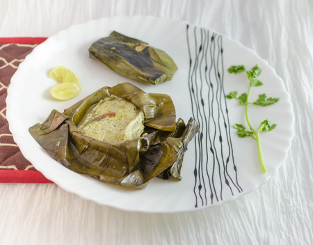 Fish Paturi is considered a delicacy in Bengali cuisine. The fish is seasoned with mustard sauce ,wrapped in banana leaves and steamed.の写真素材