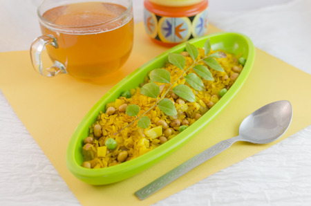 Poha is a popular Indian snack made from rice flakes. The rice flakes are lightly fried in oil with mustard,chilly,onion,curry leaves,peanuts and turmeric. It is also eaten as a breakfast .の写真素材