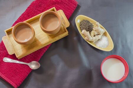 Ginger Tea is prepared by adding grated ginger to the boiling tealeaves,sugar and milk. It is traditionally consumed in clay cups.の写真素材