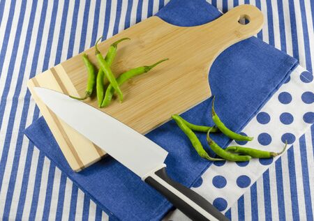 cutting board with green chilliesの写真素材