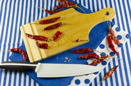 red chillies with cutting boardの写真素材