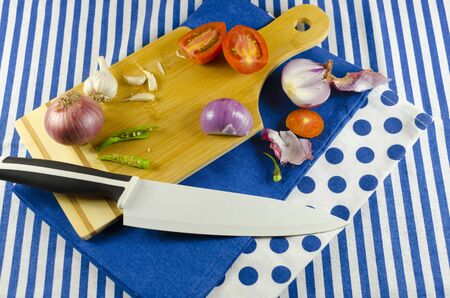 onions,green chillies,tomato,garlic for choppingの写真素材