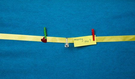 Marry me propose with ring on blue backgroundの写真素材