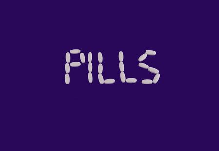 Pills isolated on violet backgroundの写真素材