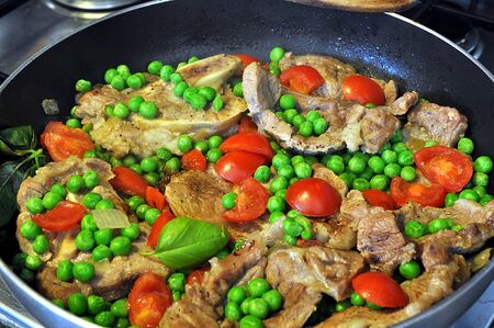 Italian recipe: marrow bone with tomatoes and peasの写真素材