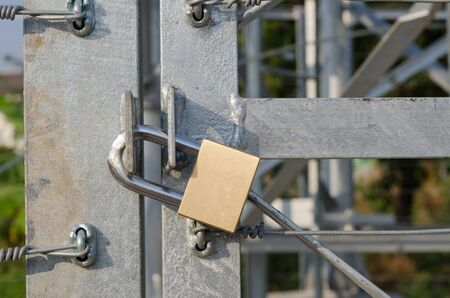 steel door of warehouse is lock with Locked brass keys.の写真素材