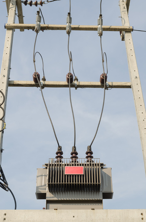 High-voltage substation on blue sky background.