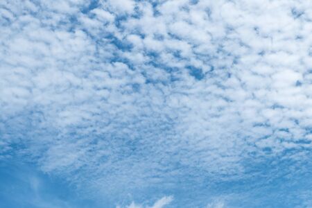 White heap clouds  in the blue sky background.