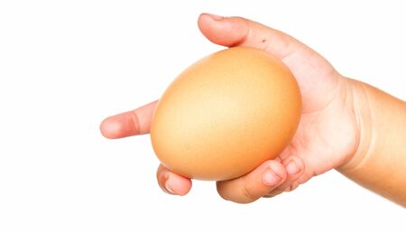Fresh Eggs are holding by hand isolated in white background.の写真素材