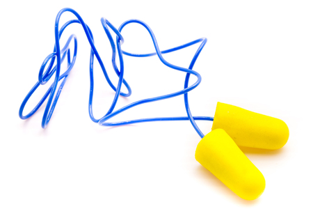 Yellow earplugs with blue band on white background.の写真素材