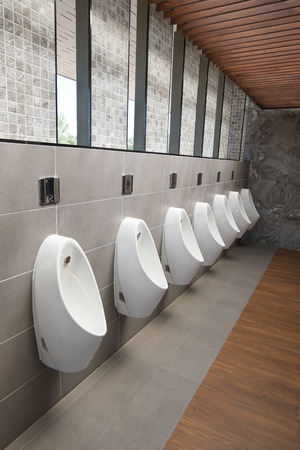 Urinals Men public in toilet room. White urinals ceramic in men's bathroom.の写真素材