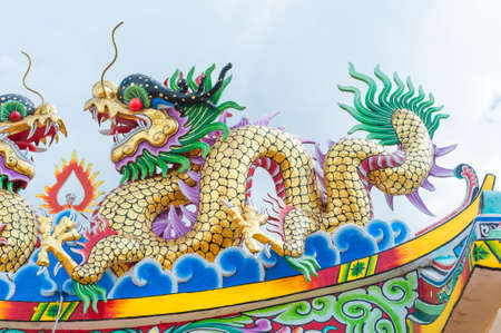 Golden dragon - Statue in a chinese temple in thailand.のeditorial素材