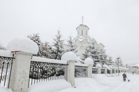 Snowstorm in Russia. Old Church under the snowの写真素材