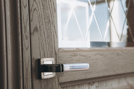 Modern style door handle on wooden doorの写真素材