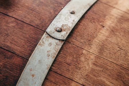 Old wooden wine barrel with iron hoops.