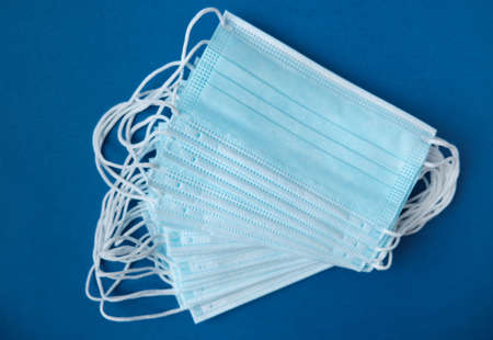 Medical mask, medical protective mask on blue background. prevent coronavirus. Disposable surgical...