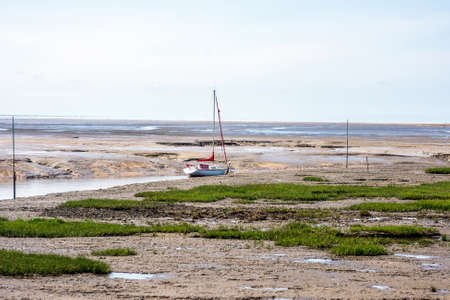 A yacht moored on the River Alt estuary at Hightown, Merseyside, UK.のeditorial素材