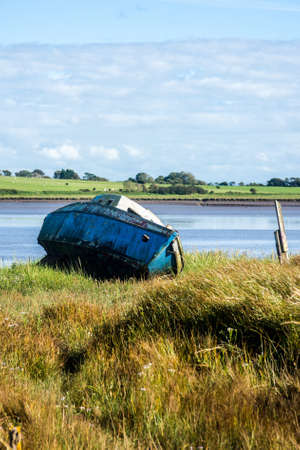 An old boat on the banks of the River Wyre, Lancashire, UK.の写真素材