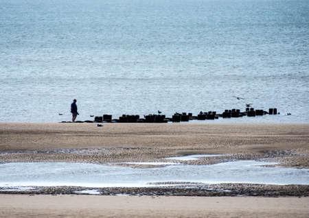 A man gazes out to sea at Blackpool, Lancashire, UK.の写真素材
