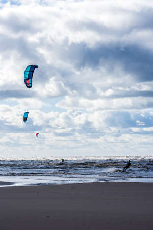 Kite surfers enjoying their sport in the Irish sea at Ainsdale, near Southport UK.の写真素材