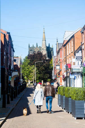 A couple walk their dog in Church Street, Ormskirk, Lancashire.の写真素材