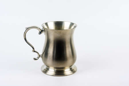 A silver drinking tankard made from metal.
