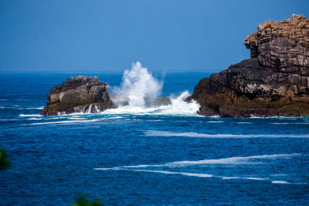 The sea crashes against rocks at Bryher, Scilly Isles, UKの写真素材