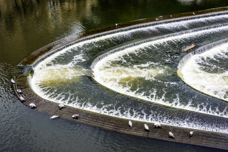 The weir is on the River Avon and just down river from Pulteney Bridge.の写真素材