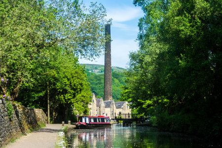 An old mill chimney on the Rochdale canal at Hebden Bridge, Yorkshire, UK.の写真素材
