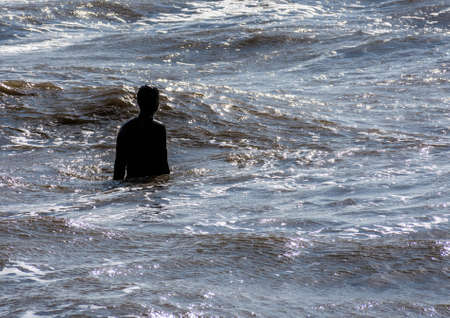 This staue is part of Anthony Gormley's "Another Place" at Crosby, near Liverrpool, UK.の写真素材