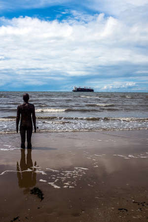 A container ship leaves the port of Liverpool and heads seaward.の写真素材