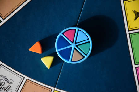 Colorful board game pieces with percentages collected in a pie wheelのeditorial素材