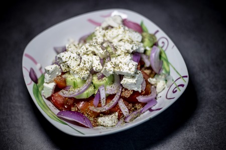 delicious traditional homemade Greek salad with tomatoes, onion, greek cheese feta , mashed and virgin olive oilの写真素材