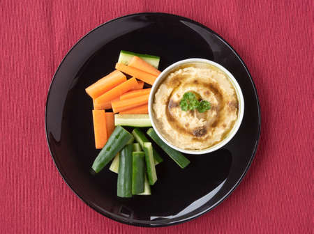 Homemade hummus with cucumber and carrot