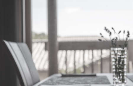 Blurred Background: blur dining room table, flower vase with bokeh light backgroundの写真素材