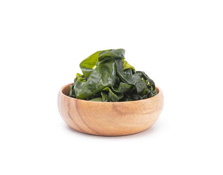 Fresh seaweed wakame in wooden bowl isolated on white background. Japanese foodの写真素材
