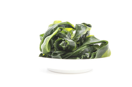 Fresh seaweed wakame on white plate isolated on white background. selective focus.の写真素材
