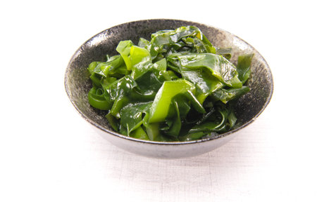 Laminaria (Kelp) Seaweed in black ceremic bowl. Japanese healthy food.の写真素材