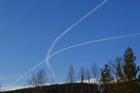 Blue sky with traces of jetsの写真素材