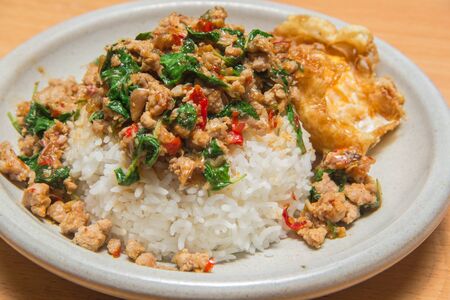spicy stir-fried pork curry and egg on dishの写真素材