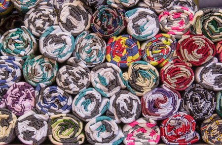 A background of rolls of colored fabric
