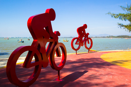red bicycle sculpture on the beach in thailandの写真素材